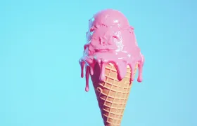 Pink strawberry ice cream scoop melting down a waffle cone