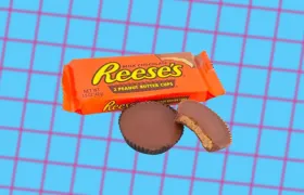 Reese's Peanut Butter Cups orange wrapper beside two chocolate cups