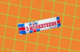 Vintage 3 Musketeers candy bar wrapper on orange grid background