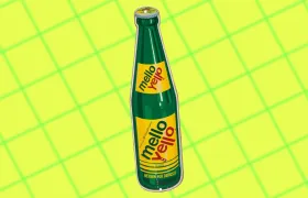 Vintage green glass Mello Yello bottle on yellow grid background