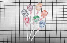 Seven wrapped Dum-Dums lollipops against a black and white grid