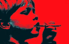 Child in profile holding a candy cigarette to their lips