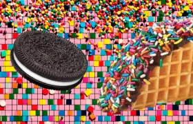 Oreo cookie beside chocolate-dipped waffle taco shell covered in rainbow sprinkles