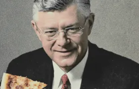 Older man in a dark suit holding a slice of pizza