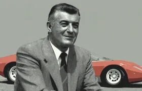 Ferruccio Lamborghini in a suit beside a red Lamborghini sports car