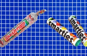American Smarties candy roll beside two Nestle Smarties chocolate candy tubes