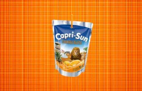 Capri-Sun Safari Fruits juice pouch with straw on orange background