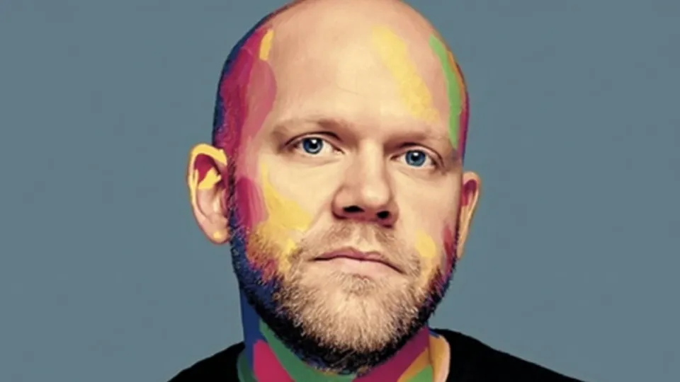 Bald bearded man portrait with colorful paint splashed across his face