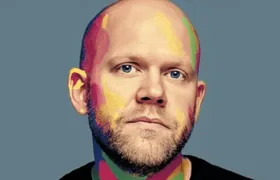 Bald bearded man portrait with colorful paint splashed across his face